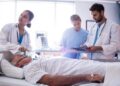 Female doctor putting oxygen mask on patient face in the hospital